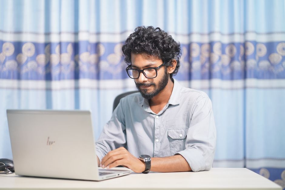 A remote software developer working on a fintech application, showcasing modern technology and innovative design.
