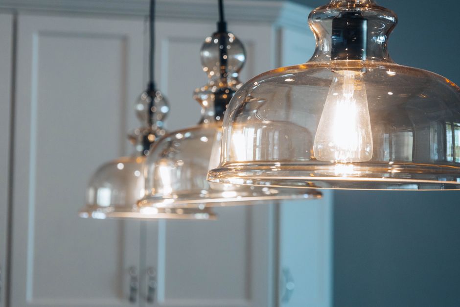 Suspension moderne au design élégant illuminant un salon contemporain avec un style chic et chaleureux.